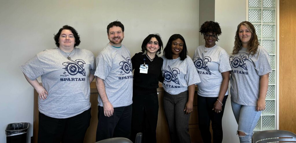 Six Phi Theta Kappans smiling, posed for a group photo.