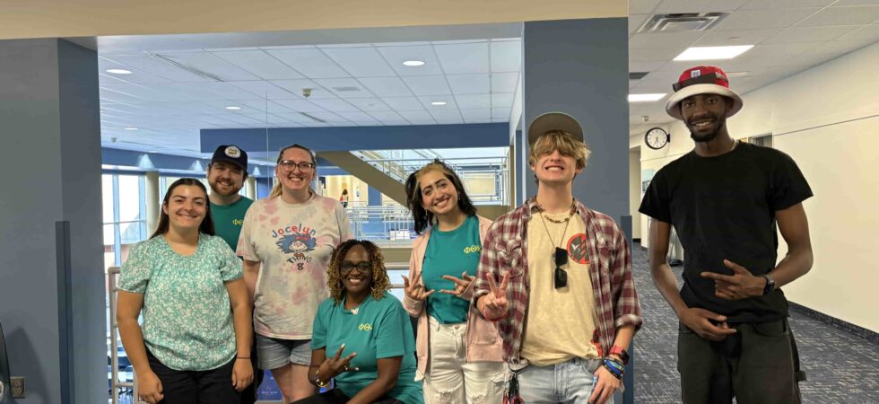 Seven Phi Theta Kappans posing for a photograph.