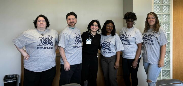 Six Phi Theta Kappans smiling, posed for a group photo.