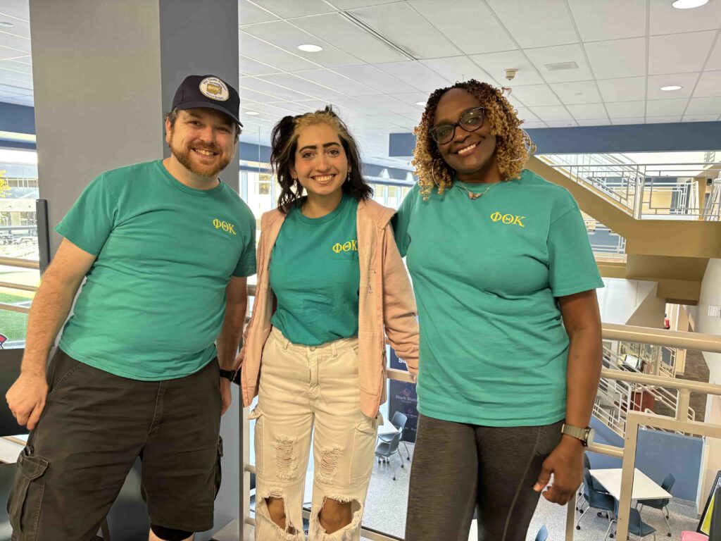 Three Phi Theta Kappa Beta Gamma Epsilon Chapter Officers: President Benjamin Nash, Vice President Salma Abueteen, Chapter Engagement Officer Tammy Monroe. They're smiling and posing for a photograph.