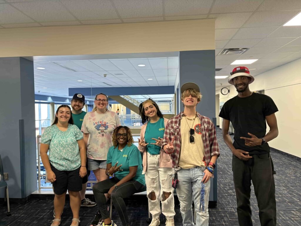 Seven Phi Theta Kappans posing for a photograph.